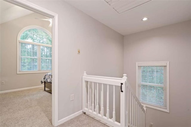 corridor with carpet floors, recessed lighting, an upstairs landing, and baseboards