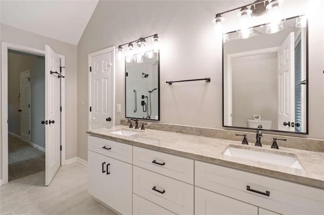 bathroom with lofted ceiling, walk in shower, a sink, and toilet