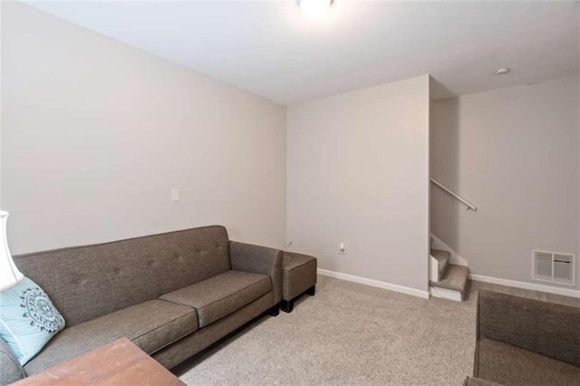 living room with carpet floors, visible vents, stairway, and baseboards