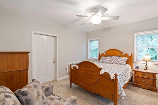 bedroom with baseboards, a ceiling fan, and light colored carpet