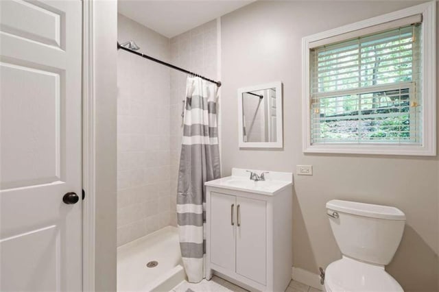 bathroom with a stall shower, vanity, and toilet