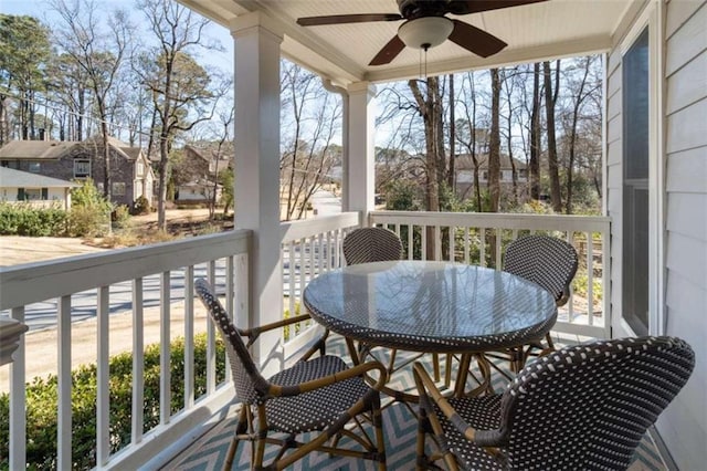 balcony featuring outdoor dining area and a ceiling fan