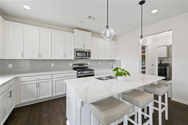 1998 Lakeview Bend Way, Buford, GA 30519 - kitchen with appliances with stainless steel finishes, decorative backsplash, white cabinetry, dark wood-style floors, and recessed lighting