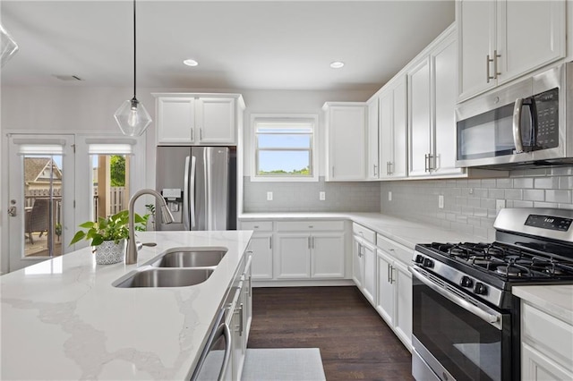 1998 Lakeview Bend Way, Buford, GA 30519 - kitchen featuring appliances with stainless steel finishes, healthy amount of natural light, white cabinetry, decorative backsplash, and recessed lighting