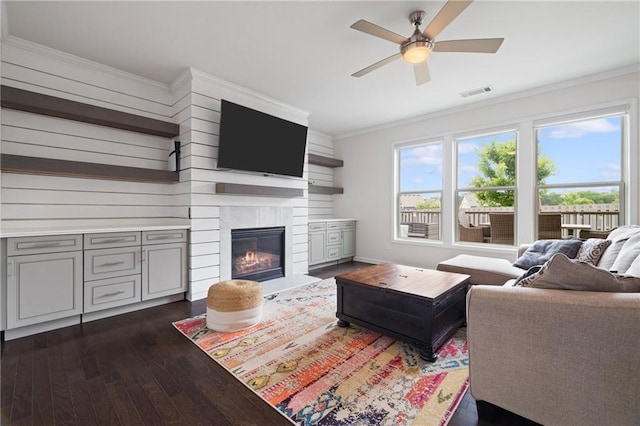 1998 Lakeview Bend Way, Buford, GA 30519 - living room with dark wood-style floors, ceiling fan, crown molding, and a fireplace with flush hearth