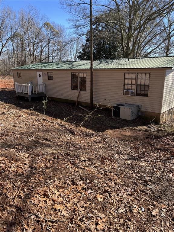 back of house featuring central air condition unit