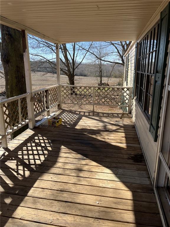 wooden deck featuring a rural view