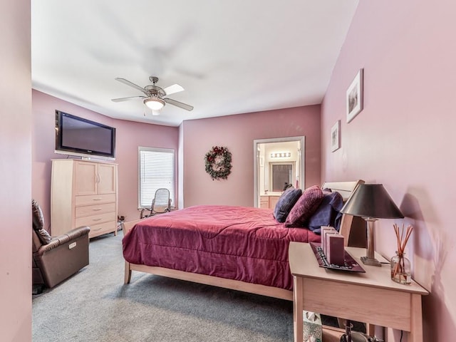 carpeted bedroom with a ceiling fan and ensuite bathroom