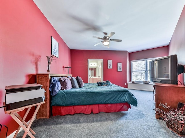 carpeted bedroom with a ceiling fan and connected bathroom