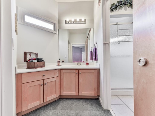 full bath featuring a shower with door, tile patterned floors, and vanity