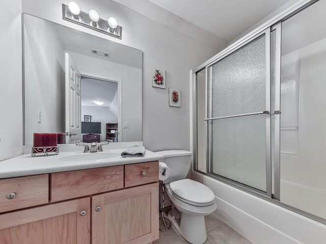 bathroom featuring tile patterned floors, visible vents, toilet, enclosed tub / shower combo, and vanity