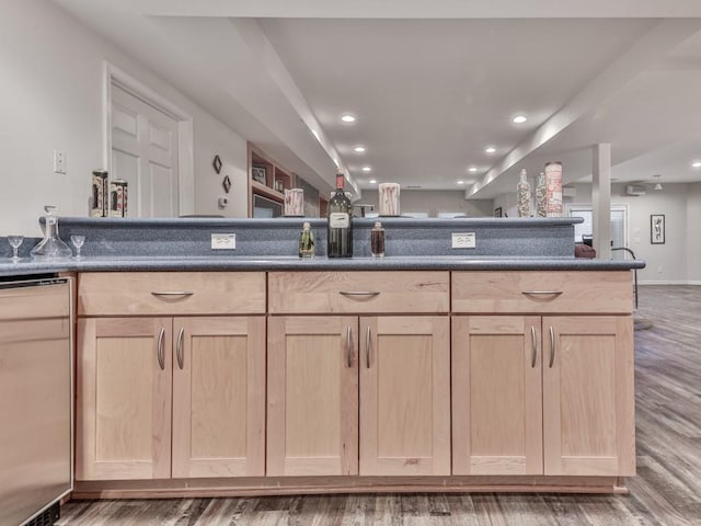 kitchen featuring dark countertops, recessed lighting, wood finished floors, and light brown cabinetry