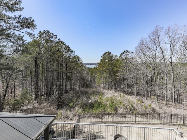 view of yard featuring fence and a view of trees