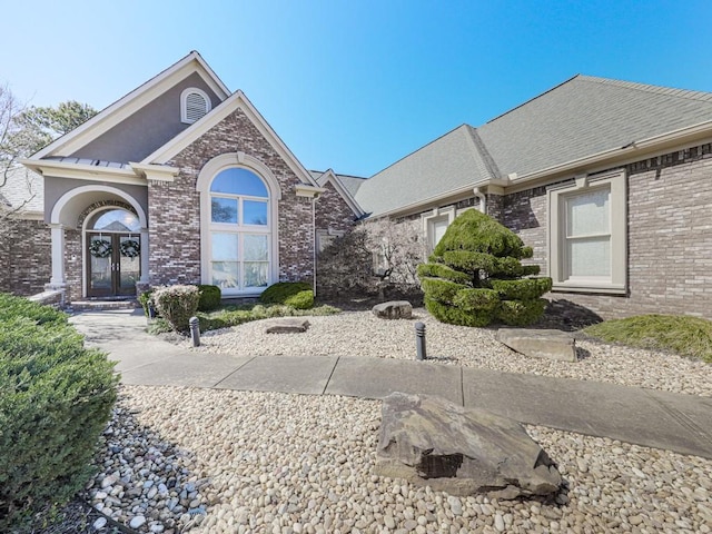 view of front of house with french doors and brick siding