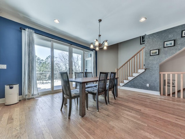 unfurnished dining area featuring stairway, baseboards, recessed lighting, hardwood / wood-style flooring, and a chandelier