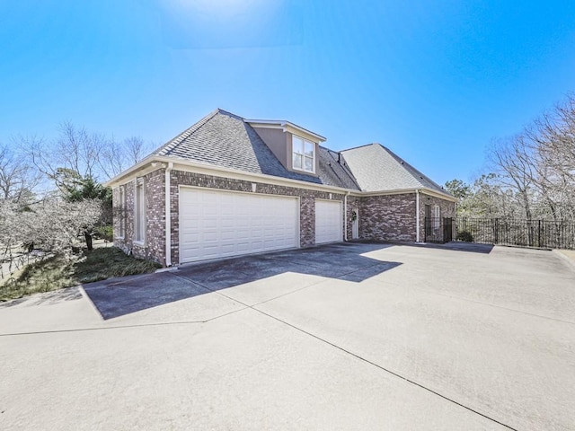 view of front of home featuring brick siding, a shingled roof, fence, concrete driveway, and an attached garage