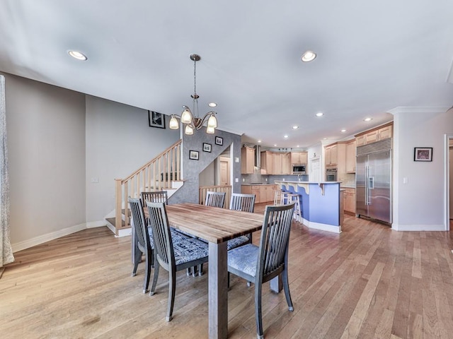 dining space featuring light wood-style flooring, recessed lighting, stairway, an inviting chandelier, and baseboards