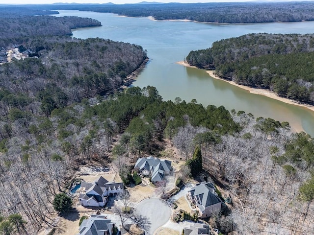 birds eye view of property featuring a view of trees and a water view