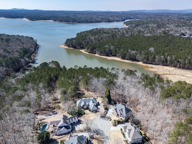 drone / aerial view featuring a view of trees and a water view