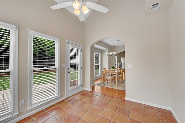 1712 Bonnabel Trce NE, Marietta, GA 30066 - interior space with arched walkways, a chandelier, light tile patterned flooring, baseboards, and ceiling fan