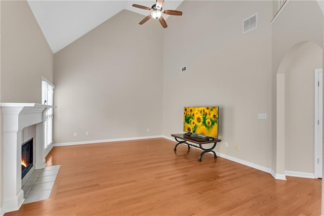 1712 Bonnabel Trce NE, Marietta, GA 30066 - unfurnished room with high vaulted ceiling, a ceiling fan, arched walkways, light wood-style floors, and a fireplace