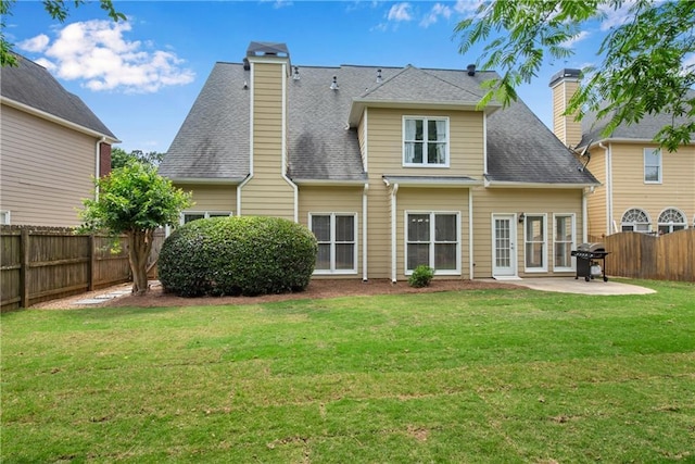 1712 Bonnabel Trce NE, Marietta, GA 30066 - back of property featuring a patio, a chimney, and roof with shingles