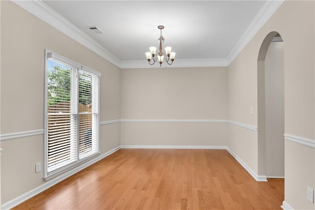 1712 Bonnabel Trce NE, Marietta, GA 30066 - spare room featuring light wood-style flooring, a chandelier, arched walkways, ornamental molding, and baseboards