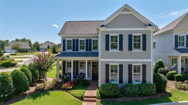 view of front of house featuring a porch and a front yard