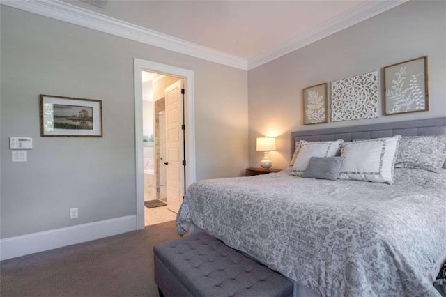 carpeted bedroom with ornamental molding and ensuite bath