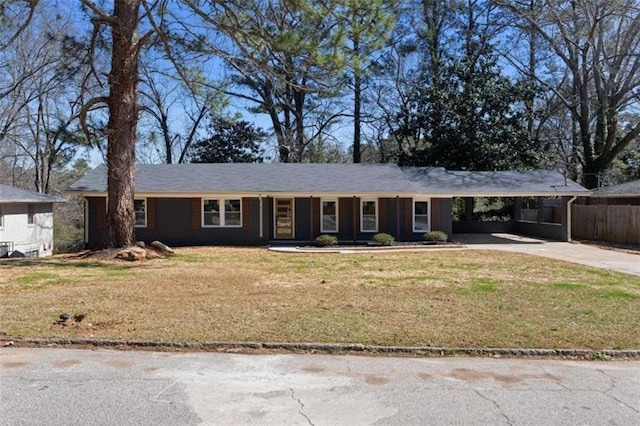 ranch-style house featuring a carport, driveway, and a front lawn