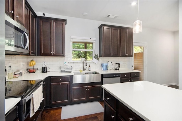 2517 Hedgeway Cir, Kennesaw, GA 30144 - kitchen featuring appliances with stainless steel finishes, backsplash, dark wood finished floors, light countertops, and dark brown cabinets