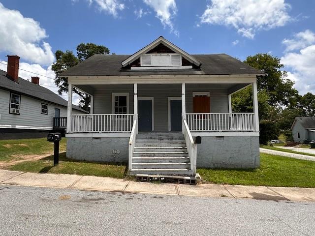 6 Hazel St, Porterdale, GA 30014 - bungalow-style home with a porch, stairs, and crawl space
