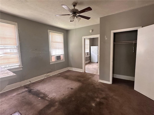 6 Hazel St, Porterdale, GA 30014 - unfurnished bedroom featuring a textured ceiling, a closet, freestanding refrigerator, carpet, and a ceiling fan
