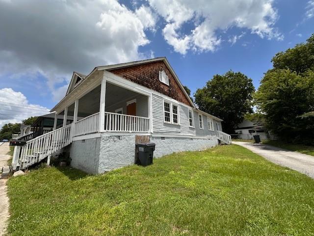 6 Hazel St, Porterdale, GA 30014 - view of property exterior with a yard, stairs, a porch, and crawl space