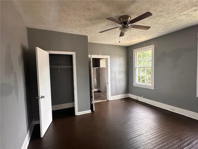 6 Hazel St, Porterdale, GA 30014 - unfurnished bedroom featuring wood finished floors, a closet, a textured ceiling, and ceiling fan