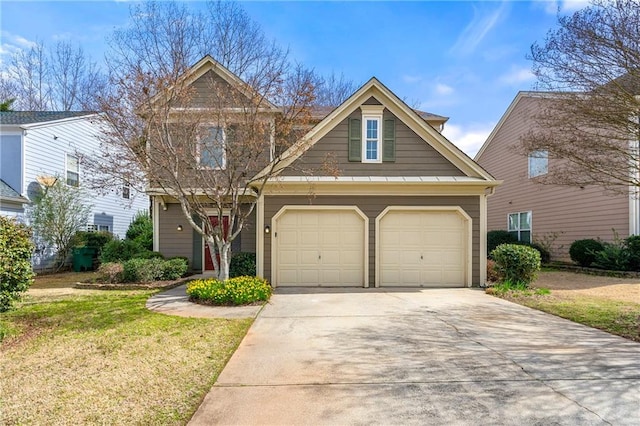 view of front of property featuring a front yard, an attached garage, and driveway