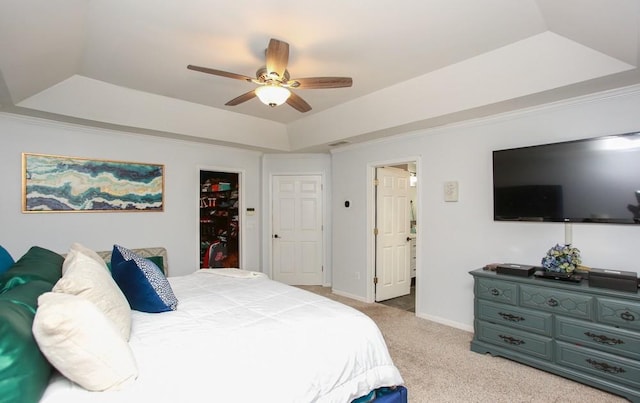 bedroom with ceiling fan, light carpet, a raised ceiling, and baseboards