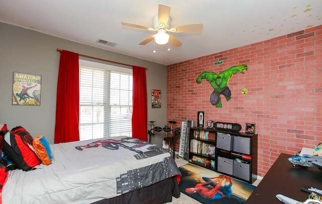 bedroom with a ceiling fan, visible vents, and brick wall