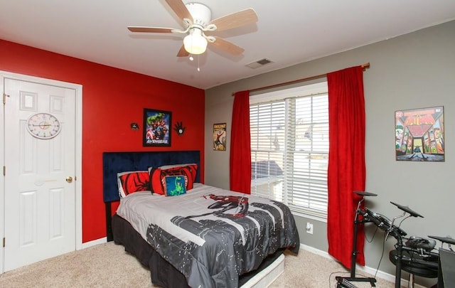 carpeted bedroom with baseboards, visible vents, and a ceiling fan