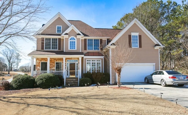 view of front of house with a garage, covered porch, concrete driveway, and stone siding
