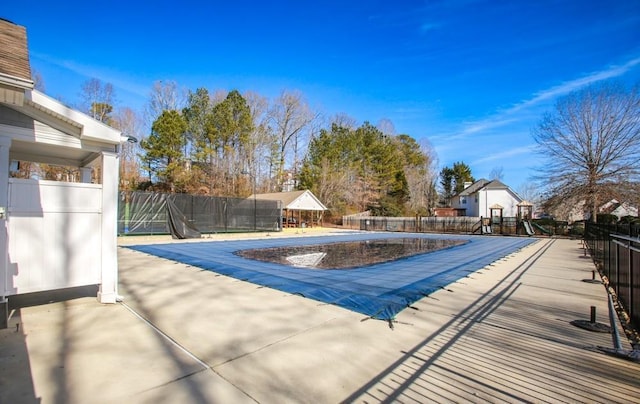 community pool with playground community and fence