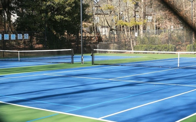 view of sport court featuring fence