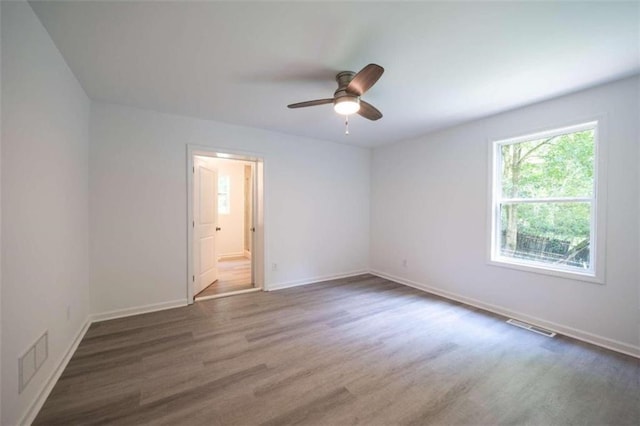 unfurnished room featuring ceiling fan and dark hardwood / wood-style flooring