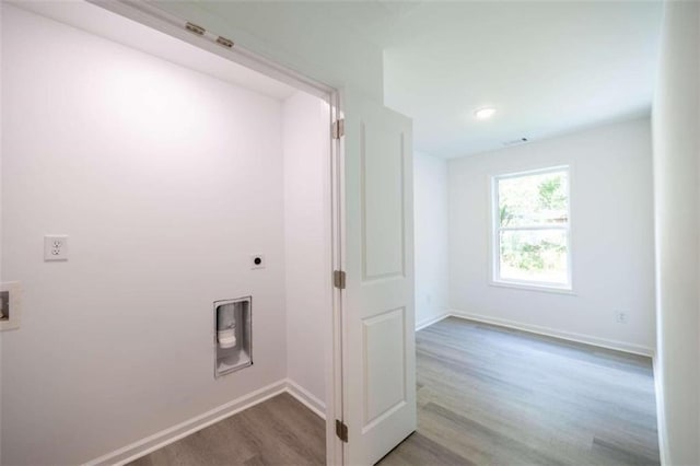 washroom featuring hookup for an electric dryer and light wood-type flooring