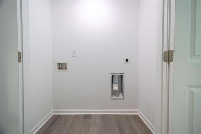 laundry area with hookup for an electric dryer, hardwood / wood-style floors, and washer hookup