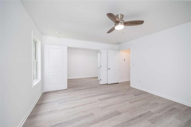 unfurnished room featuring light hardwood / wood-style floors and ceiling fan