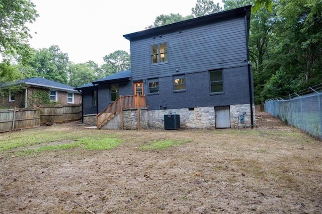 rear view of house with central AC unit