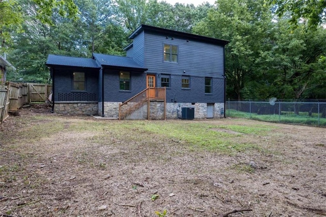 rear view of house featuring central AC