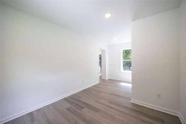 unfurnished room with wood-type flooring