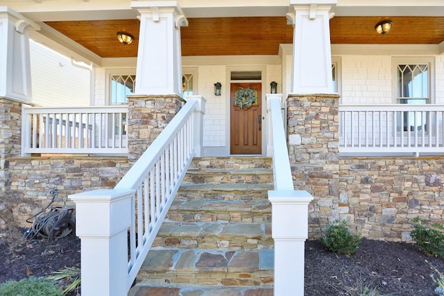 view of exterior entry with a porch